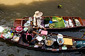 Thailand, Locals sell fruits, food and products at Damnoen Saduak floating market near Bangkok 